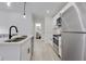 Sleek kitchen with a waterfall island, stainless steel appliances, and adjacent to the living area at 1452 Fletcher Ave, Indianapolis, IN 46203