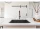 Close-up of a modern black kitchen sink with a stylish faucet on a quartz countertop at 1452 Fletcher Ave, Indianapolis, IN 46203