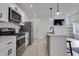 Bright, open kitchen with stainless steel appliances, white cabinetry, and sleek countertops at 1452 Fletcher Ave, Indianapolis, IN 46203