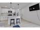 Modern kitchen features stainless steel appliances, a breakfast bar, and pendant lighting at 1452 Fletcher Ave, Indianapolis, IN 46203