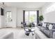 Bright living room with contemporary furniture, large windows, and elegant decor at 1452 Fletcher Ave, Indianapolis, IN 46203