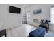 Well-lit living room with a wall-mounted TV, comfortable seating, and stylish decor at 1452 Fletcher Ave, Indianapolis, IN 46203