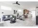 Open-concept living room and dining area with modern furniture, white walls, and light-colored floors at 1452 Fletcher Ave, Indianapolis, IN 46203