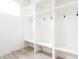 Bright mudroom with white shelving, hooks, and seating, perfect for organization and storage at 1452 Fletcher Ave, Indianapolis, IN 46203