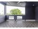 Cozy covered patio with unique flooring and view of the backyard, ideal for relaxation at 1452 Fletcher Ave, Indianapolis, IN 46203
