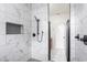 Beautiful shower with marble-look tile, black plumbing fixtures, and a convenient in-shower niche at 1452 Fletcher Ave, Indianapolis, IN 46203