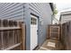 A functional side door enclosed by a wooden fence and gravel, adding privacy at 1452 Fletcher Ave, Indianapolis, IN 46203
