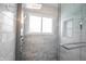 Shower with modern marble tile, glass door, and a rainfall shower head at 1477 Macintosh Ct, Avon, IN 46123