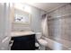 This well-lit bathroom boasts a shower with marbled tile and a stylish dark vanity with a neutral countertop at 1477 Macintosh Ct, Avon, IN 46123