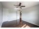 This light-filled bedroom features a ceiling fan and rich, dark-toned hardwood flooring at 1477 Macintosh Ct, Avon, IN 46123