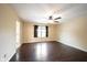 Bedroom featuring hardwood floors, a ceiling fan, and a window offering natural light at 1477 Macintosh Ct, Avon, IN 46123