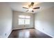 Bedroom featuring hardwood floors, a ceiling fan, and a window offering natural light at 1477 Macintosh Ct, Avon, IN 46123