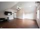 Spacious bonus room with hardwood floors, ceiling fan, a TV, and natural light from the window at 1477 Macintosh Ct, Avon, IN 46123