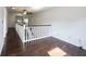 Sun-drenched hallway featuring gleaming hardwood floors and a staircase with white banisters at 1477 Macintosh Ct, Avon, IN 46123