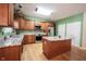 Bright kitchen features stainless steel appliances, granite countertops, and wood cabinets at 1477 Macintosh Ct, Avon, IN 46123