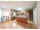 Open kitchen with stainless steel appliances, wood cabinets, an island and hardwood flooring at 1477 Macintosh Ct, Avon, IN 46123