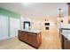 Open kitchen featuring island with granite counters, wood cabinets, and eat-in breakfast area at 1477 Macintosh Ct, Avon, IN 46123