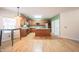 Bright kitchen boasts an island, stainless steel appliances, granite countertops, and wood cabinets at 1477 Macintosh Ct, Avon, IN 46123