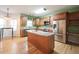 Spacious kitchen with an island, stainless steel appliances, granite countertops, and wooden cabinets at 1477 Macintosh Ct, Avon, IN 46123