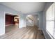 Open concept living room with wood floors and a view of the staircase and kitchen at 1477 Macintosh Ct, Avon, IN 46123