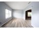 Bright, airy living room with wood floors and neutral paint and large windows at 1477 Macintosh Ct, Avon, IN 46123
