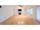 Bright living room with fireplace, hardwood floors, and large windows, bathed in natural light at 1477 Macintosh Ct, Avon, IN 46123