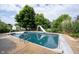 An in-ground pool featuring a slide, basketball hoop, and mature landscaping creates a private outdoor oasis at 1477 Macintosh Ct, Avon, IN 46123