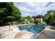 An in-ground pool featuring a slide, basketball hoop, and mature landscaping creates a private outdoor oasis at 1477 Macintosh Ct, Avon, IN 46123