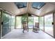 Sunroom features multiple glass panels, views of the backyard pool, and comfortable seating at 1477 Macintosh Ct, Avon, IN 46123