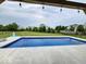 Beautiful backyard featuring a sparkling in-ground pool, patio, and well-maintained lawn at 15873 Hush Hickory Bnd, Westfield, IN 46074