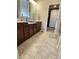 A clean bathroom with a large mirror and dark brown cabinets at 15873 Hush Hickory Bnd, Westfield, IN 46074