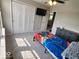 This carpeted bedroom has a ceiling fan, TV, closet, and window at 15873 Hush Hickory Bnd, Westfield, IN 46074