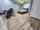Comfortable bedroom with wood flooring, ceiling fan, a window allowing natural light, desk and comfortable chair at 15873 Hush Hickory Bnd, Westfield, IN 46074