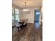 Dining room with a wooden table, floral-patterned chairs, and lots of natural light at 15873 Hush Hickory Bnd, Westfield, IN 46074