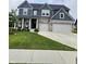Beautiful two-story home with a well-manicured lawn and a three-car garage at 15873 Hush Hickory Bnd, Westfield, IN 46074