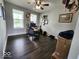 Bright home office with two windows, dark floors, and a ceiling fan at 15873 Hush Hickory Bnd, Westfield, IN 46074