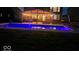 Stunning in-ground pool at dusk with a covered patio area illuminated by string lights at 15873 Hush Hickory Bnd, Westfield, IN 46074