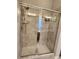 Modern tiled shower with glass doors and dual shower heads at 15873 Hush Hickory Bnd, Westfield, IN 46074
