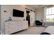 Bedroom featuring a barn door to bathroom, stylish dresser and a view of neighborhood through a bright window at 15958 Meadow Frost Ct, Fishers, IN 46037