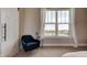 Cozy bedroom nook featuring an accent chair with a view of the neighborhood through a bright window at 15958 Meadow Frost Ct, Fishers, IN 46037