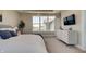 Cozy main bedroom with a large window, neutral decor, and a view of the neighborhood, offering comfort and style at 15958 Meadow Frost Ct, Fishers, IN 46037
