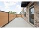 View of a fenced backyard with a brick house and covered patio area at 1677 Solebar Way, Westfield, IN 46074