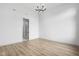 Bright, empty bedroom featuring wood-look flooring, white walls, and modern lighting at 1677 Solebar Way, Westfield, IN 46074
