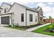 Charming home featuring sleek black window frames, a dark garage door, and a well-manicured lawn at 1677 Solebar Way, Westfield, IN 46074