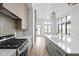 Modern kitchen with stainless steel appliances, center island, and open layout to the living area at 1677 Solebar Way, Westfield, IN 46074