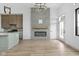 Open concept living room and kitchen featuring modern fireplace and stainless steel appliances at 1677 Solebar Way, Westfield, IN 46074