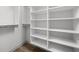 Empty walk-in closet with built in shelving and laminate flooring at 1677 Solebar Way, Westfield, IN 46074