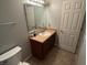 Cozy bathroom with single sink vanity, framed mirror, tiled floor, and a neutral color palette at 1711 Jaques Dr, Lebanon, IN 46052