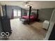 Comfortable bedroom boasts a four-poster bed, ceiling fan, and neutral walls at 1711 Jaques Dr, Lebanon, IN 46052
