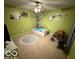 Playful bedroom with a tree painted on the wall and a fun alphabet rug at 1711 Jaques Dr, Lebanon, IN 46052
